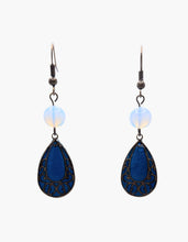 Load image into Gallery viewer, Deep, jewel-toned, and completely unforgettable. The Peacock Lace Teardrop Earrings set a rich peacock blue polymer clay backing inside a wide teardrop frame of antique bronze brass, filled with an intricate botanical scrollwork pattern. The depth of the blue glows through every opening in the filigree, creating a jewel-like effect that is bold, beautiful, and entirely one-of-a-kind. Peacock blue against aged bronze. Deep color behind delicate lace. The combination is striking without being overdone.