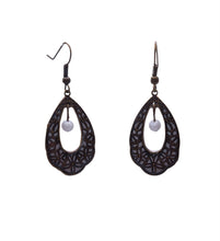 Load image into Gallery viewer, The quietest bloom in the garden, and somehow the one you cannot stop looking at.
The White Petal Teardrop Filigree Earrings frame a soft white polymer clay backing inside an intricate teardrop-shaped filigree in warm antique bronze brass. At the center of the open cutout, a single plain white glass bead hangs freely, catching the light with every movement.
White on bronze. Clean on ornate. Simple on intricate. The contrast is effortless and completely beautiful.