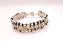 Load image into Gallery viewer, There is something quietly powerful about black and silver together. Cool, precise, and completely your own.
Slip Laced in Midnight onto your wrist and feel that shift from ordinary to intentional. This is the bracelet that finishes a boardroom outfit and still looks perfect over a beach dinner cocktail.
Handcrafted by Veronica of River Jewels, this bracelet is woven using a delicate lace-inspired technique combining fine seed beads and two-hole duo beads in striking Black and Silver. 
